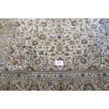 An excellent Persian Kashan carpet, central motif with foliage on cream, ground. 345cm x 245cm.