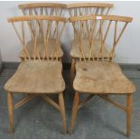 A set of four mid-century elm and beech ‘candlestick’ chairs by Ercol, having lattice spindles above