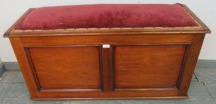 A Victorian mahogany window seat, the seat upholstered in antique crimson velvet with gold braid