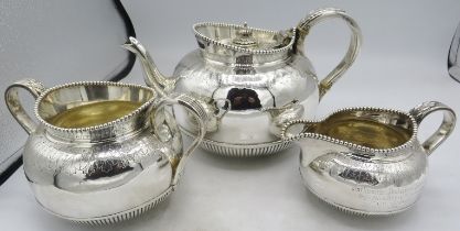 A fine Victorian silver three piece tea service with bead edge, applied acanthus leaf handles,