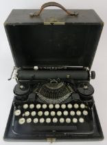 An American Underwood standard portable typewriter. Housed in a black leather carry case. Box: 31.