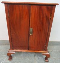 An antique flame mahogany side cabinet, the twin cock-beaded doors opening onto two fitted