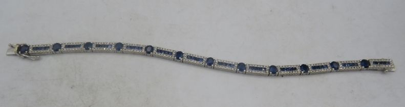 A fine Art Deco style 18ct white gold bracelet. The twelve articulated rectangular panels set with