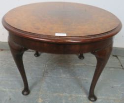 An antique burr walnut circular coffee table, the quarter veneered top with central roundel, on