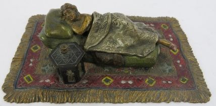An Austrian cold bronze Bergman figurine of a reclining sleeping nude lady on a rug, circa 1900.