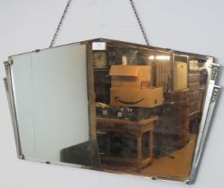 An Art Deco bevelled wall mirror with cast aluminium side detail. H38cm W70cm (approx). Condition