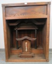 An antique Japanese elm Kamidana votive cabinet, housing a model of a Buddhist temple, the carved