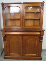 A Victorian mahogany glazed bookcase, the top section with ¾ gallery and carved heart decoration