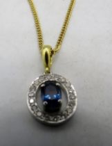 A sapphire & diamond halo pendant on an 18ct yellow gold bail. Diamonds approx 0.2cts, sapphire
