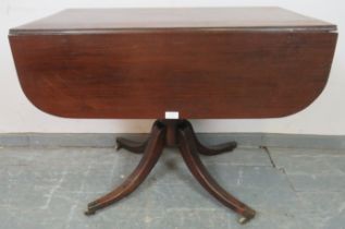 A Regency Period mahogany Pembroke table, housing single drawer and dummy drawer strung with
