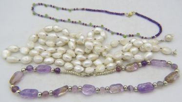 A large fresh water pearl necklace interspersed with white metal beads and having a white metal ball