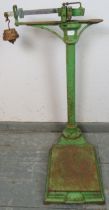 A set of antique cast iron doctor’s weighing scales, painted pea green. H89cm W54cm D60cm (