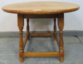 A vintage light oak circular occasional table in the 18th century taste, on baluster turned supports