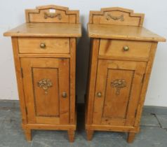 A pair of antique Continental pine bedside cabinets, each with single drawer above cupboard with
