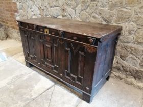 A 17th century panelled oak coffer, having applied brass plaque to lid inscribed ‘T. Clarke’, the