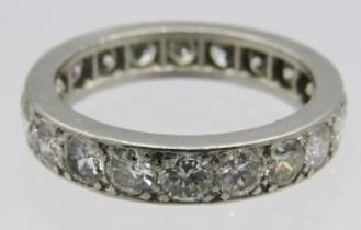 An unmarked white metal full eternity ring set with twenty diamonds, size M. Diamonds total approx