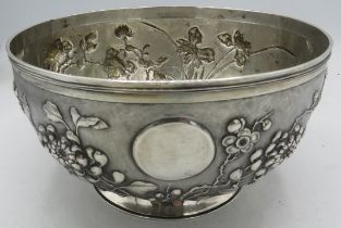 A fine Chinese silver footed bowl, embossed with chrysanthemums, iris, roses and prunus, signed