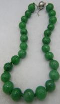 A jade necklace of large individually hand knotted 20mm stones of even size and good colour match