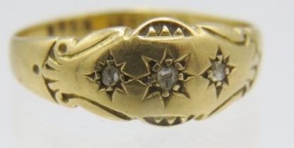 An 18ct yellow gold gypsy ring set with three small diamonds in star shaped design, Chester 1901,