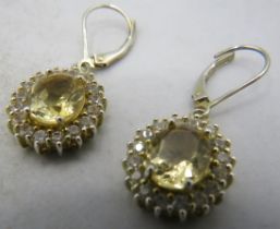 A pair of silver gilt oval cut citrine and white stone earrings, citrine approx 10mm x 8mm, lever