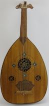 An Arabic oud string instrument, late 19th/early 20th century. 80 cm length.