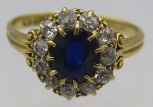 An 18ct yellow gold claw setting sapphire & diamond cluster ring. Sapphire approx 6mm x 4mm, 11
