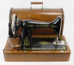A vintage Singer sewing machine. Painted black with gilt scrolling foliate decoration. Mounted on