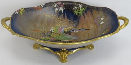 A Carlton Ware gilt and polychrome enamelled ‘sketching bird’ pattern twin handled pedestal bowl,