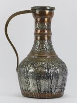 A large Middle Eastern metalwork decanter jug with embossed decoration, 19th century or earlier.