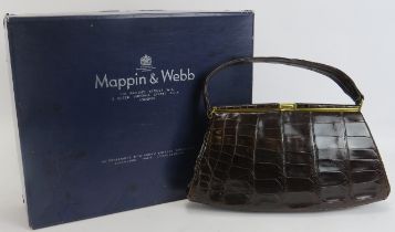 A Mappin & Webb black crocodile skin handbag. With gilt metal mounts and clasp, the interior with