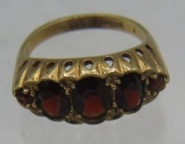 A 9ct yellow gold five stone graduated faceted garnet ring. Centre garnet approx 8mm x 4mm, size