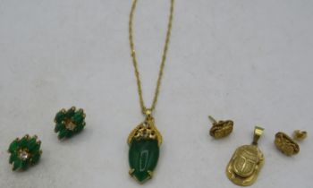 A yellow metal oval jade & white stone pendant on a yellow metal chain, jade approx 25mm x 12mm, a