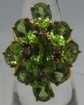 A silver gilt peridot and white stone cluster ring, each peridot approx 6mm x 4mm, marked 925,