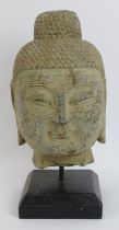 A large Chinese carved hardstone Buddha head, 20th century. 39 cm height including base. Condition