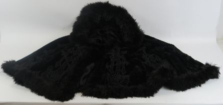 A Victorian black ostrich feather and embroidered velvet cape. 26 in approximate length. Condition