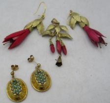 A pair of 9ct yellow gold oval earrings set with a group of turquoise coloured stones, boxed. A