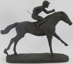 A bronzed figure of a jockey on a racehorse by David Geenty, dated '84. Signed to base. 22.2 cm