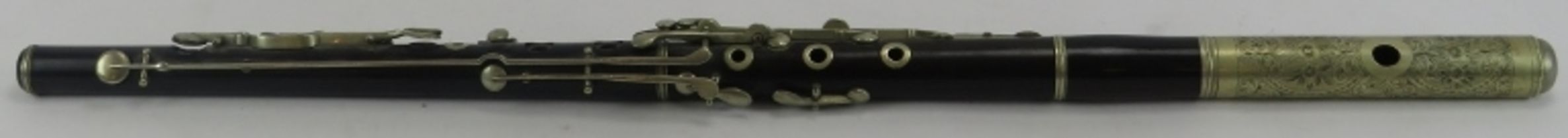 A rosewood flute, late 19th century. Composed of three sections with nickel mounted fittings. 70.5