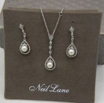 A Neil Lane silver, pearl & diamond pendant with matched drop earrings. The pearls suspended in a