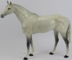A large Beswick ceramic model of a dapple grey racehorse. Model No: 1564. 28.5 cm height, 35.5 cm