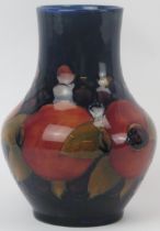 A William Moorcroft pomegranate pattern vase, circa 1930s. Of baluster form, tubeline decorated with