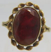 A 9ct yellow gold ring set with large oval faceted garnet, approx 15mm x 10mm, size L. Approx weight