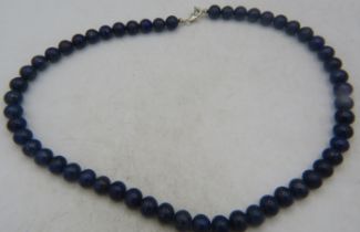 A lapis lazuli necklace of even size stone, length 18". Condition report: Good condition.