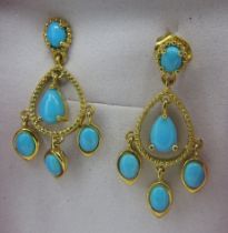 A pair of silver gilt 'Sleeping Beauty' earrings. Each earring with pear and oval set turquoise