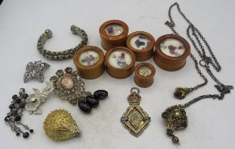 A collection of six screw top treen boxes containing various coloured stones, a silver & enamelled