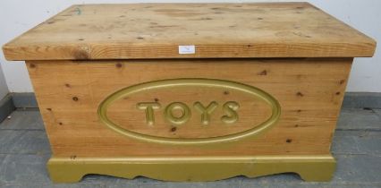 A vintage pine flat topped trunk, the front relief carved with ‘Toys’, on a plinth base. H47cm W92cm