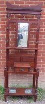 A late Victorian mahogany hall stand, the original nicely silvered mirror plate flanked by six