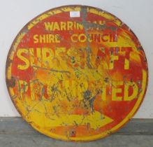 A vintage double-sided steel sign painted in yellow and orange with the slogan ‘Warning Australian