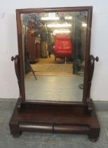 A 19th century mahogany gentleman’s swing vanity mirror, on a box base housing two short cylinder