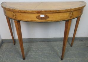 An 18th century satinwood demi-lune console table, crossbanded and parquetry strung, having burr